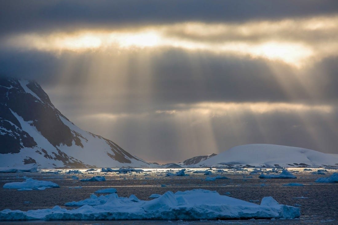 Lemaire-Channel Lemaire Channel sun beaming through clouds over ocean