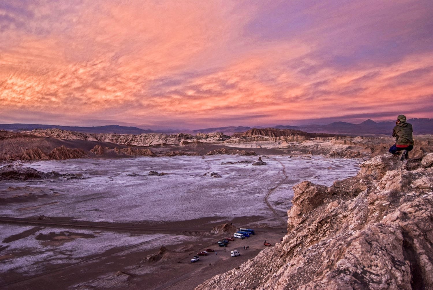 Valley-of-Moon-San-Pedro-de-Atacama Admiring the deep purple and orange sunset on leisure travel over salt lake at the Valley of the Moon in San Pedro de Atacama, Chile