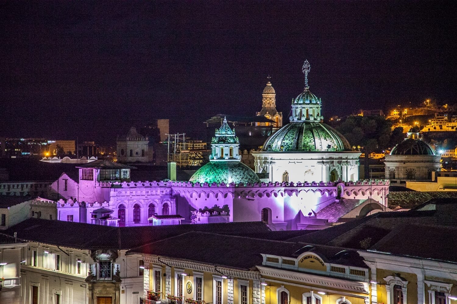 Ecuador-Travel-Quito-Night-Purple Purple blue and orange light projected on buildings in Quito Ecuador at night to change their colors
