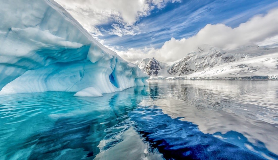 Antarctica-Landed-Travel-Private-Travel Electric blue glaciers and mirror smooth water of Antarctica, photographed during an Antarctica Cruise