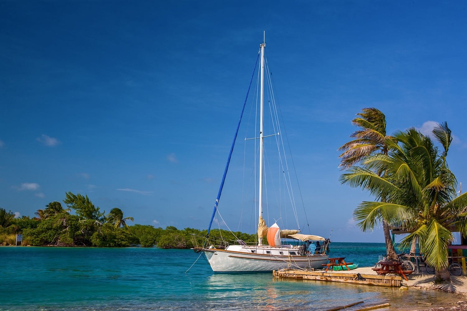 Belize-Private-Custom-Travel-Design-Caye-Caulker (1) A sailboat docked on a leisure tour of Caye Caulker in Belize