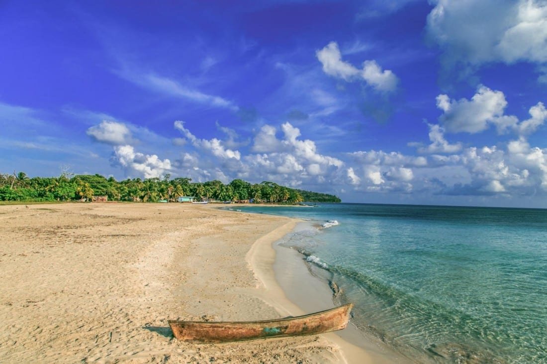 Corn-Island-Nicaragua-3-Landed-Travel-Private-Travel Fishing boat on the white sand coast of Nicaragua's Corn Island