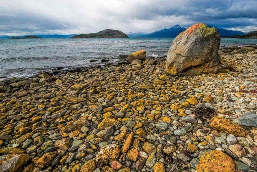 Tierra-Del-Fuego-Ushuaia-Argentina Colored yellow rocks paved the coastline inside the National Park of Tierra del Fuego, ushuaia