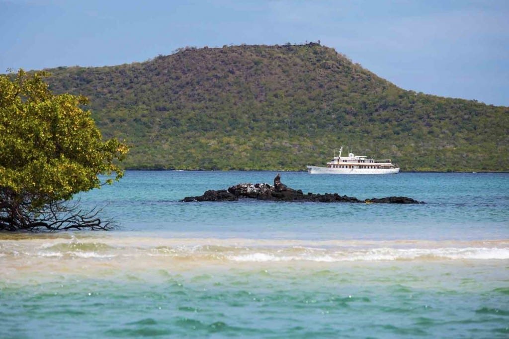 Grace-Baroness-Point Galapagos Yacht Charter M/Y Grace, cruising the crystal blue waters of Baroness Point in the Galapagos archipelago