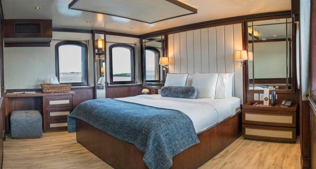 Grace-Kelly-Suite Elegant king bed and mahogany trim of the Grace Kelly Suite onboard Galapagos Islands Charter Yacht M/V Grace