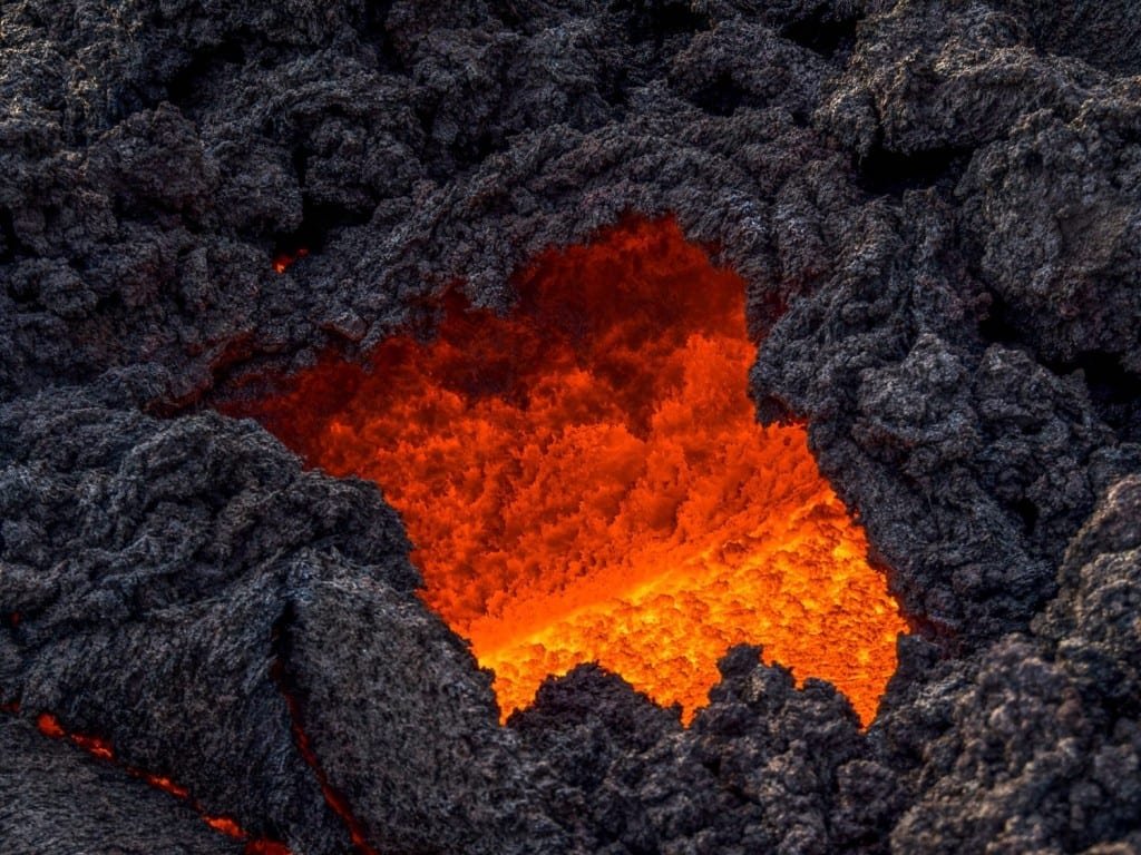 Guatemala-Private-Custom-Travel-Design-Active-Adventure-Pacaya-3 View inside cone of volcano in Guatemala, showing orange molten lava and surrounding volcanic rock
