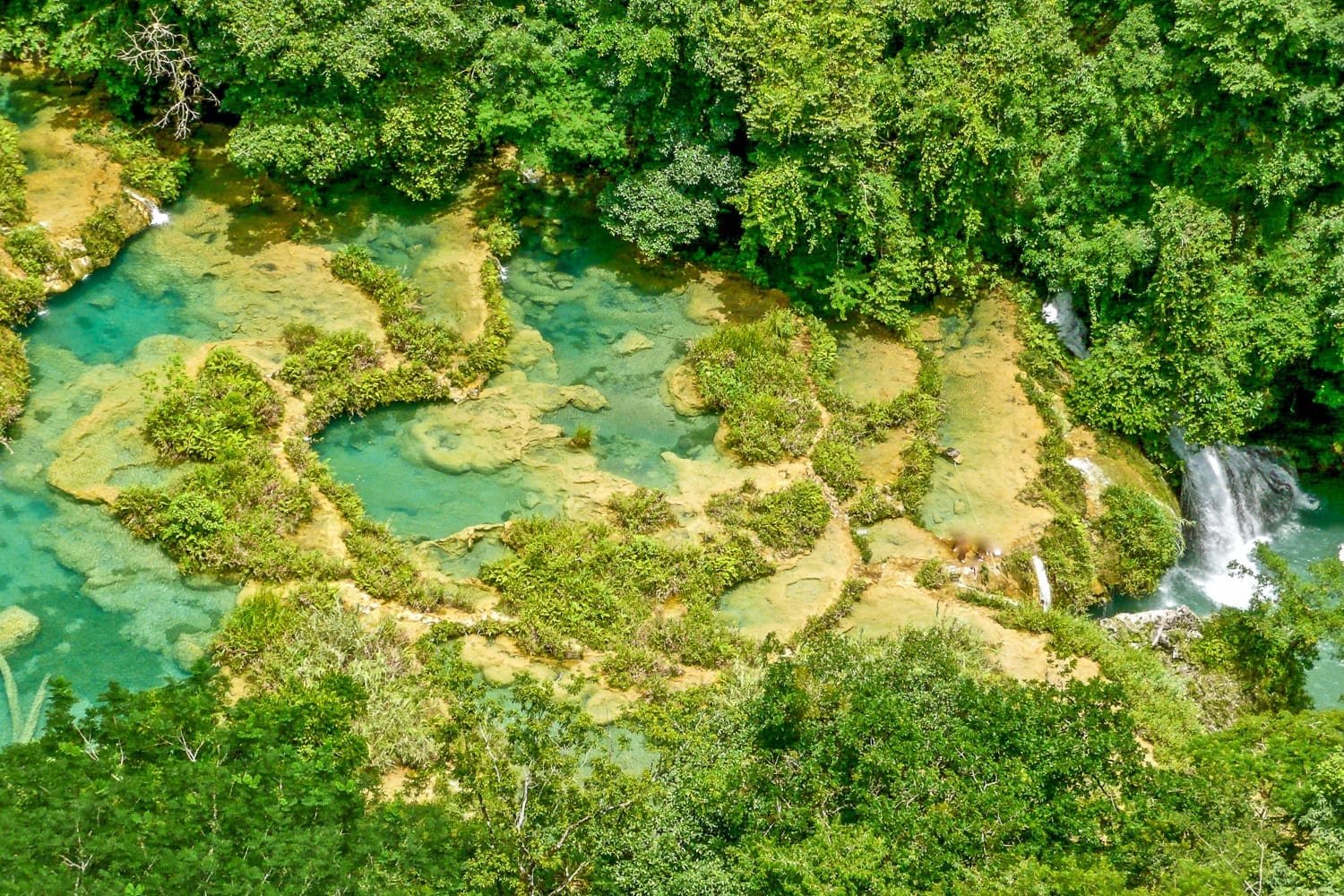 Guatemala-Private-Custom-Travel-Design-Semuc-Champey-3 Aerial photo of Semuc Champey, Verapaces, Guatemala showing clear blue water and sandstone shelfs