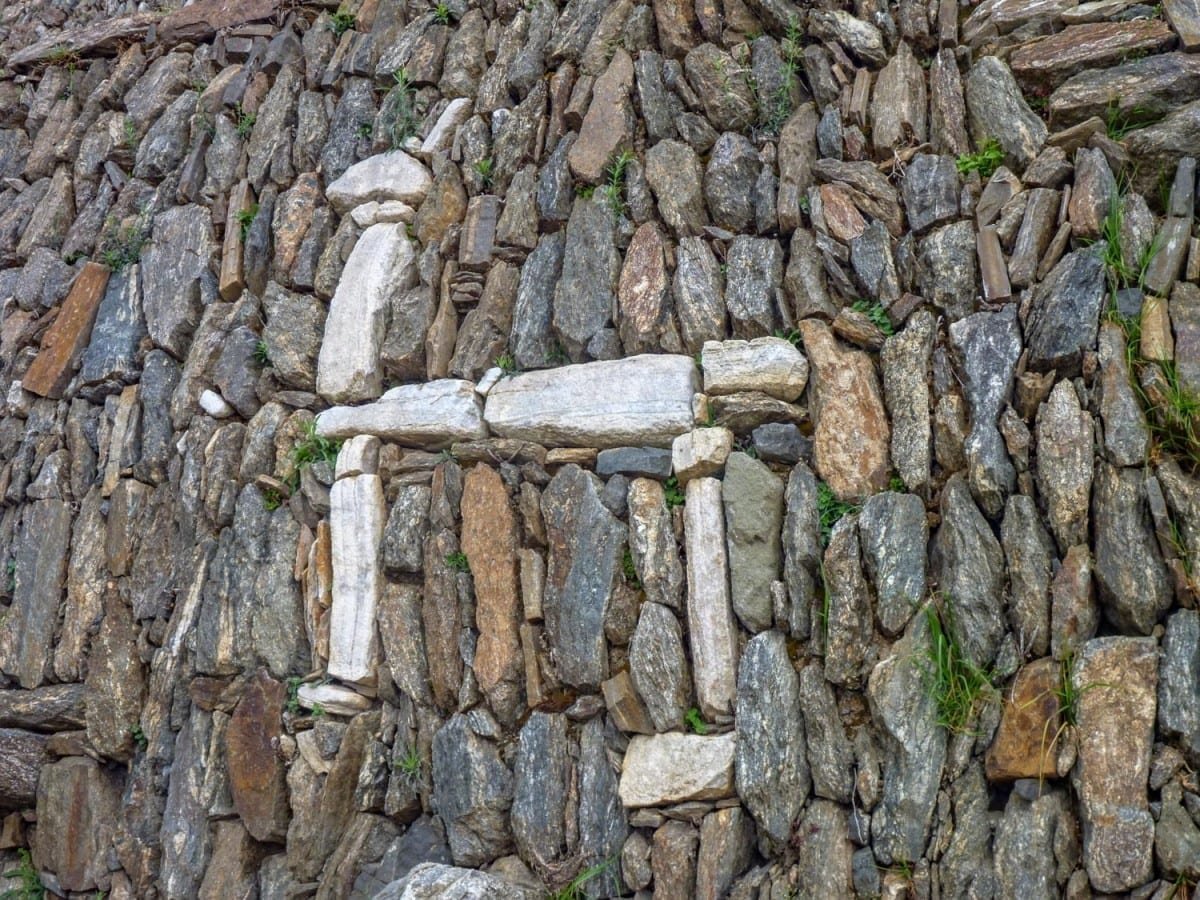 Landed-Travel-Private-Travel-Choquequirao-Llama-Wall-Detail-Peru White stone llama artwork built into stone wall at Choquequirao ruins in Peru