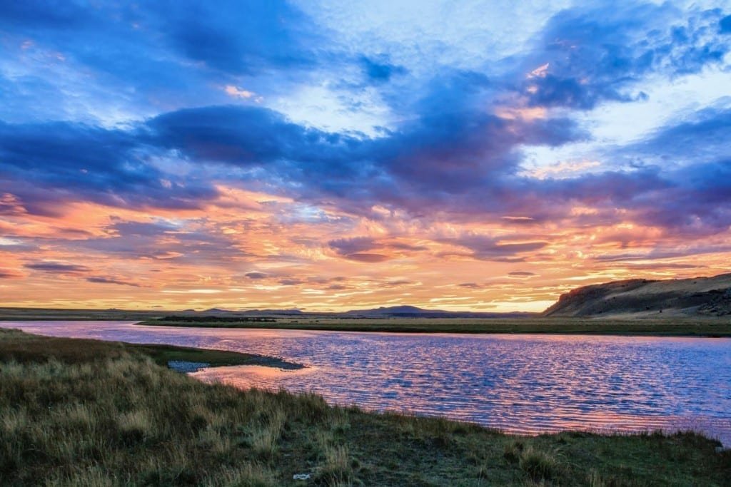 Landed-Travel-Private-Travel-Estancia-Sunset-Patagonia Purple and orange sunset over a lake at a Patagonian Estancia in Chile