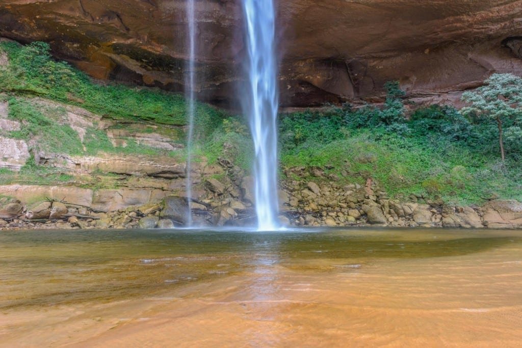 Landed-Travel-Private-Travel-Garden-of-Delight-Waterfall-Santa-Cruz-Bolivia A waterfall over a rockface with lush greenery, photographed on a nature tour in Santa Cruz, Bolivia.