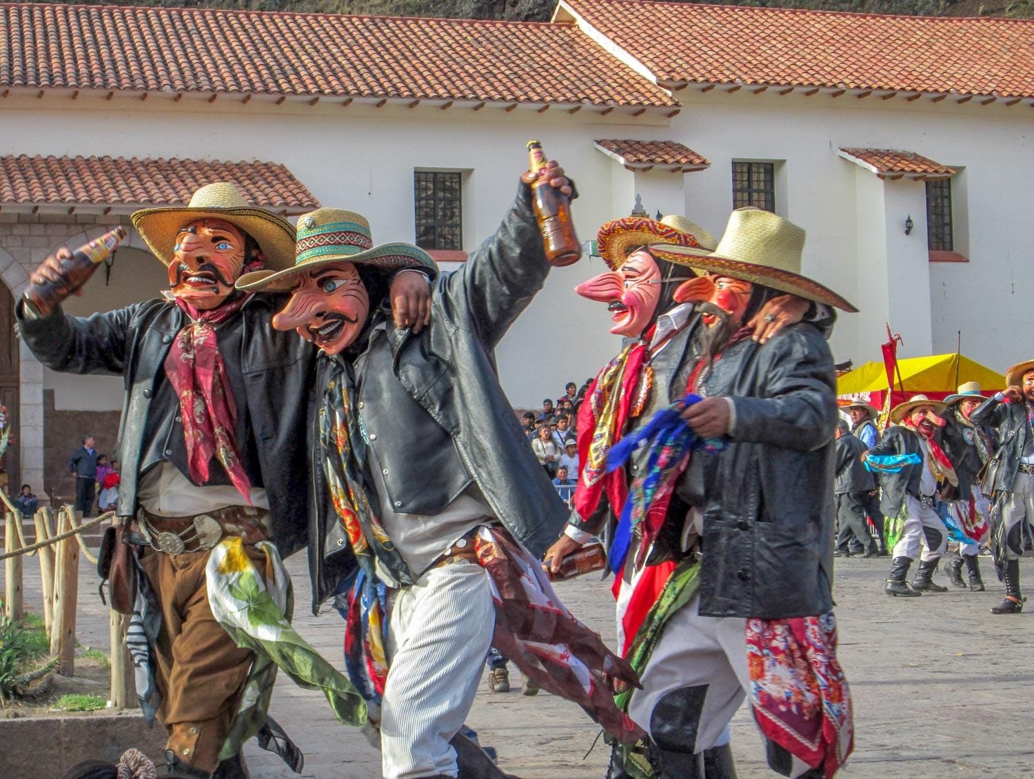 Landed-Travel-Private-Travel-Paucartambo-1-Peru Men wearing celebratory wooden masks walking town the street in Paucartambo, Peru