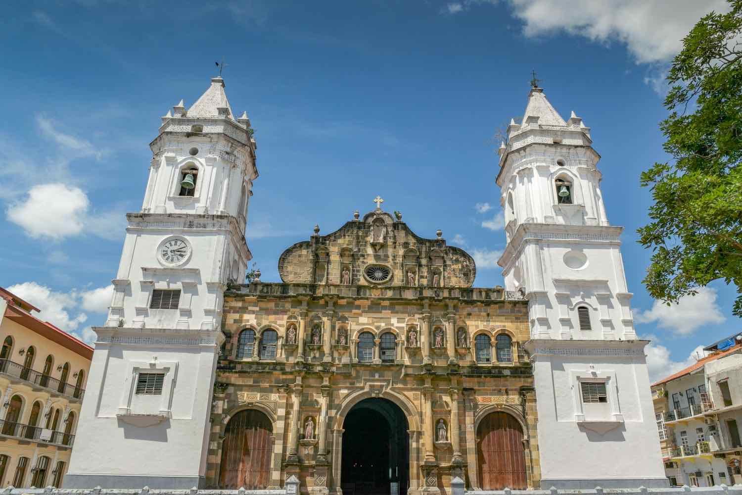 Panama-City-Cathedral-Panama-Landed-Travel-Private-Travel Historic tan brick Cathedral with twin white belltowers and Spanish Architectural influences in Panama City
