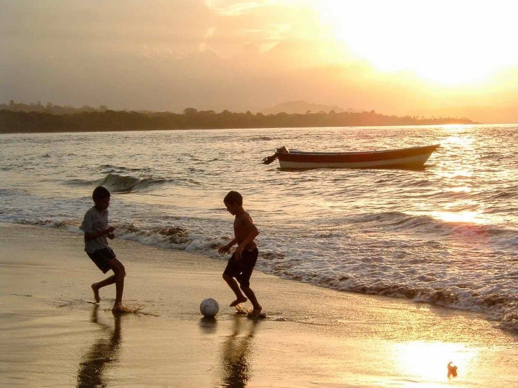 Panama-Custom-Travel-Design-Pacific-Beach-Soccer Two boys playing soccer at sunset over one of the Beaches of Panama, on the Pacific Coast