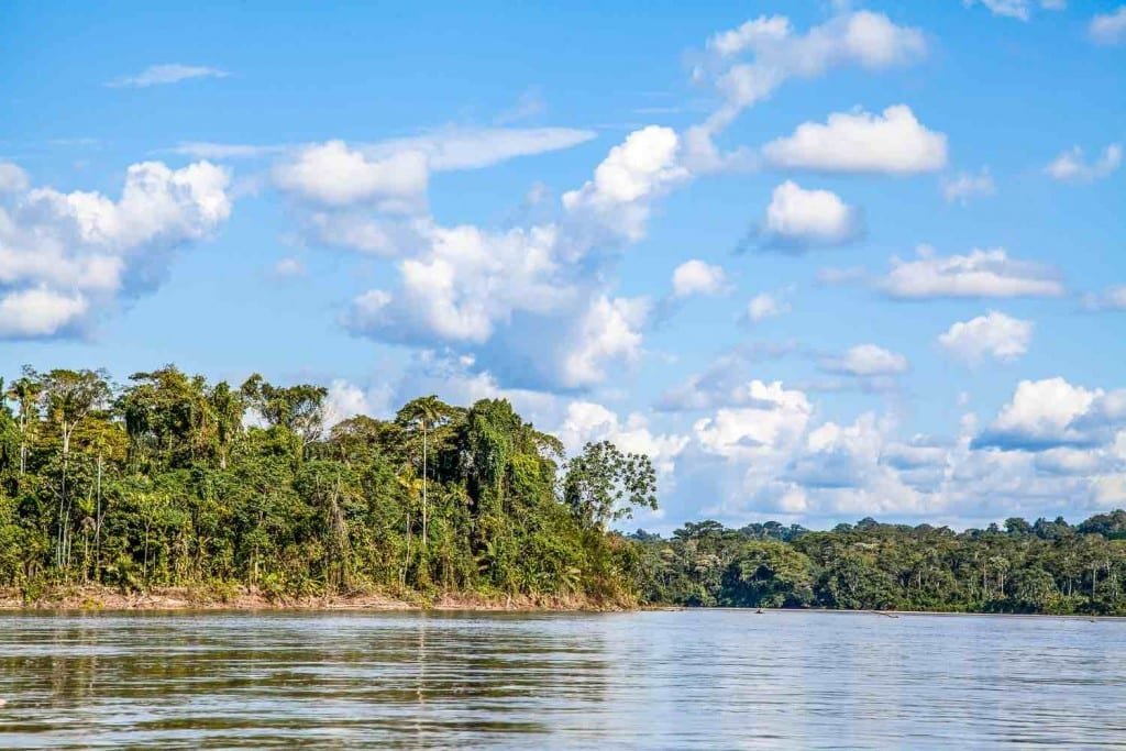 Private-Travel-Custom-Travel-Ecuador-Amazon-Clouds Clouds reflecting off Amazon River in Ecuador, banks lined with dense rainforest foliage