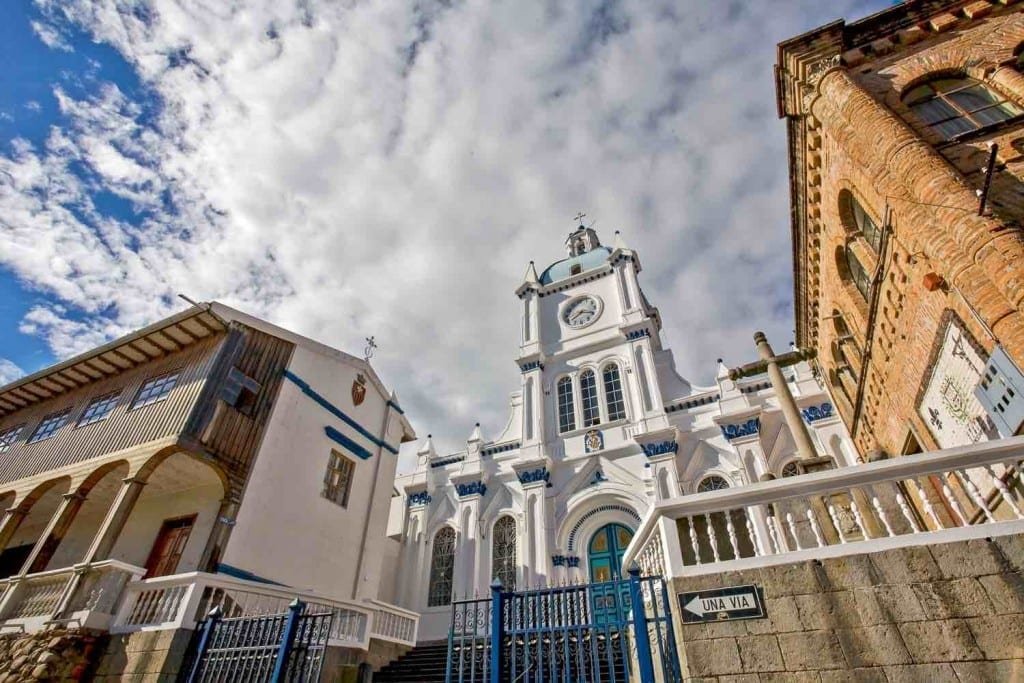Private-Travel-Custom-Travel-Ecuador-Cuenca-White-Church A white church with bright blue accents, photographed during leisure travel in Cuenca, Ecuador