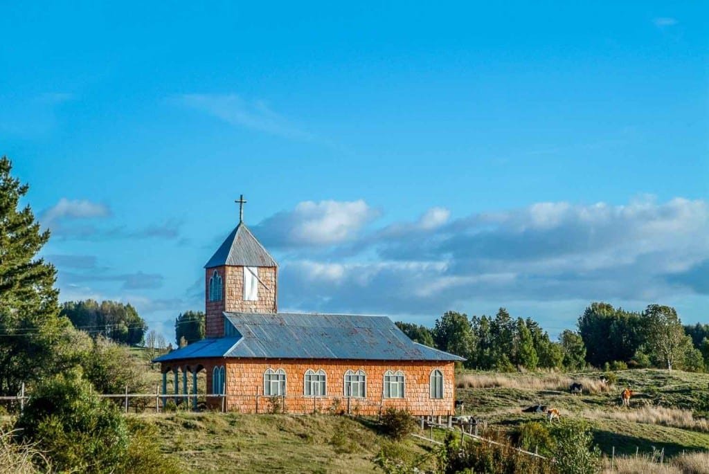 Private-Travel-Design-Chiloe-Chile-Church-Near-Castro Quaint red church on a hillside near Castro, Chiloe Island