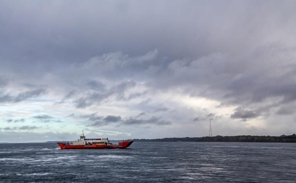 Private-Travel-Design-Chiloe-Chile-Ferry Large red commercial ferry in the water off the coast of Chiloe Island, Chile