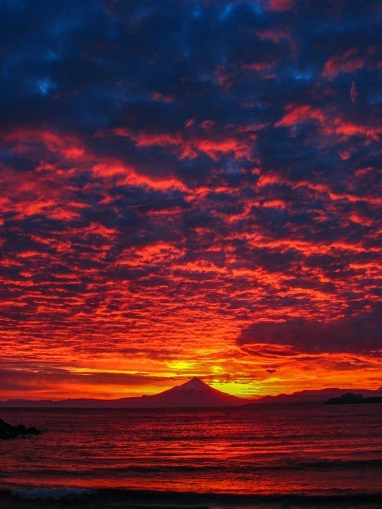 Private-Travel-Design-Puerto-Varas-Chile-Sunset Fiery red sunset over the lake in Puerto Varas, Chile, Volcano in the distance