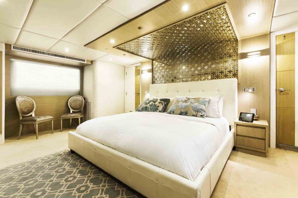 Stella Maris Yacht Cabin Cabin of one of LANDED's most elegant Galapagos Luxury Charters, Stella Maris Yacht, with gold accents and luxury bed linens