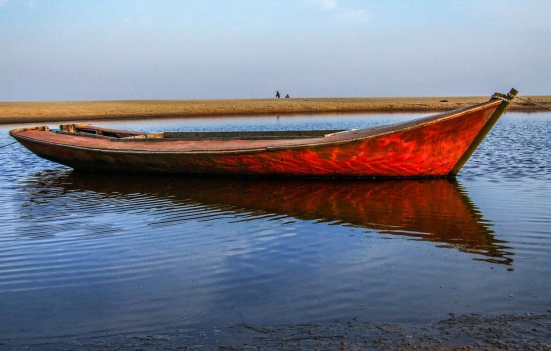 Uruguay-TravelPrivate-Travel-Custom-Vacation-Valaiza-Beach Small red boat in the shallows off Valaiza Beach in Uruguay