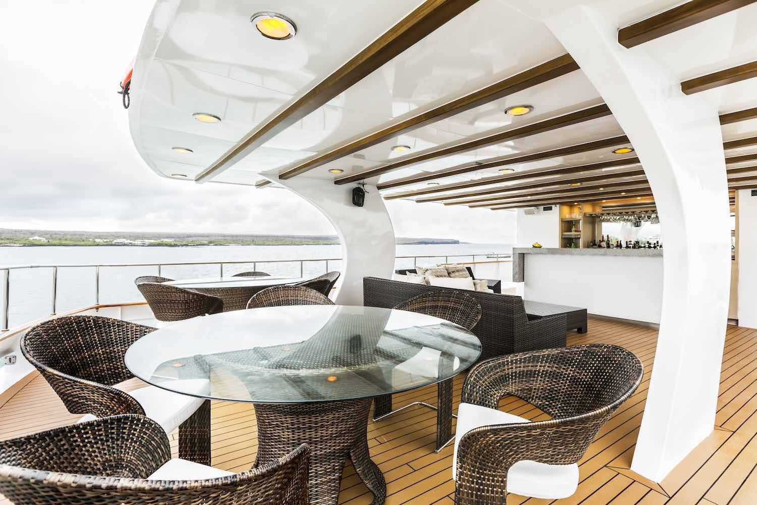 Stella-Maris-Galapagos-Bar-Yacht View of bar and alfresco dining table onboard Galapagos Charter Yacht M/Y Stella Maris