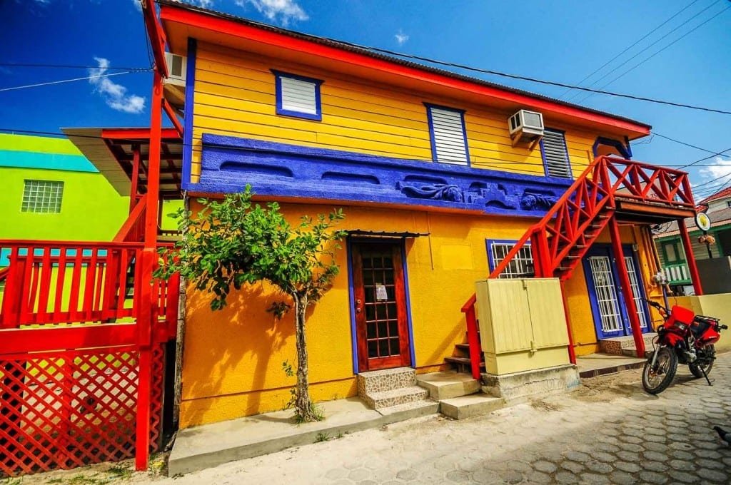 Belize-Private-Custom-Travel-Design-Ambergris-Caye-8 vibrant yellow and red house Ambergris