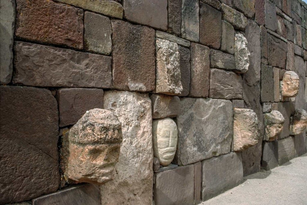 Bolivia-Private-Custom-Travel-Design-Tiwanaku-Tenoned-Head-Wall exposed faces carved into a stone wall Tiwanaku