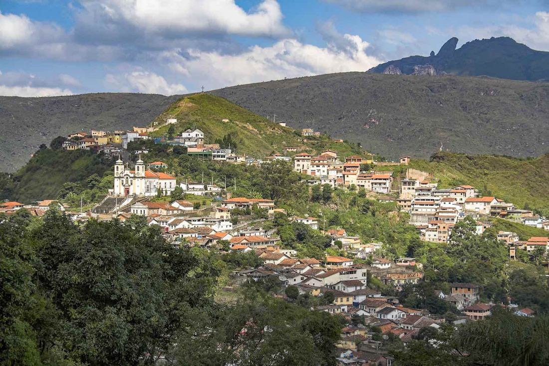 Brazil-Private-Custom-Travel-Design-Ouro-Preto-Panorama Green hill in Ouro Preto Brazil, dotted with quaint white houses