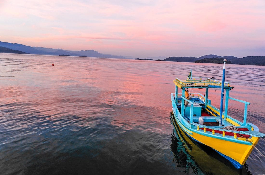 parati-boat-sunset A colorful boat on the water at sunset in the bay of beautiful portuguese colonial town of Parati Rio de Janeiro, Brazil