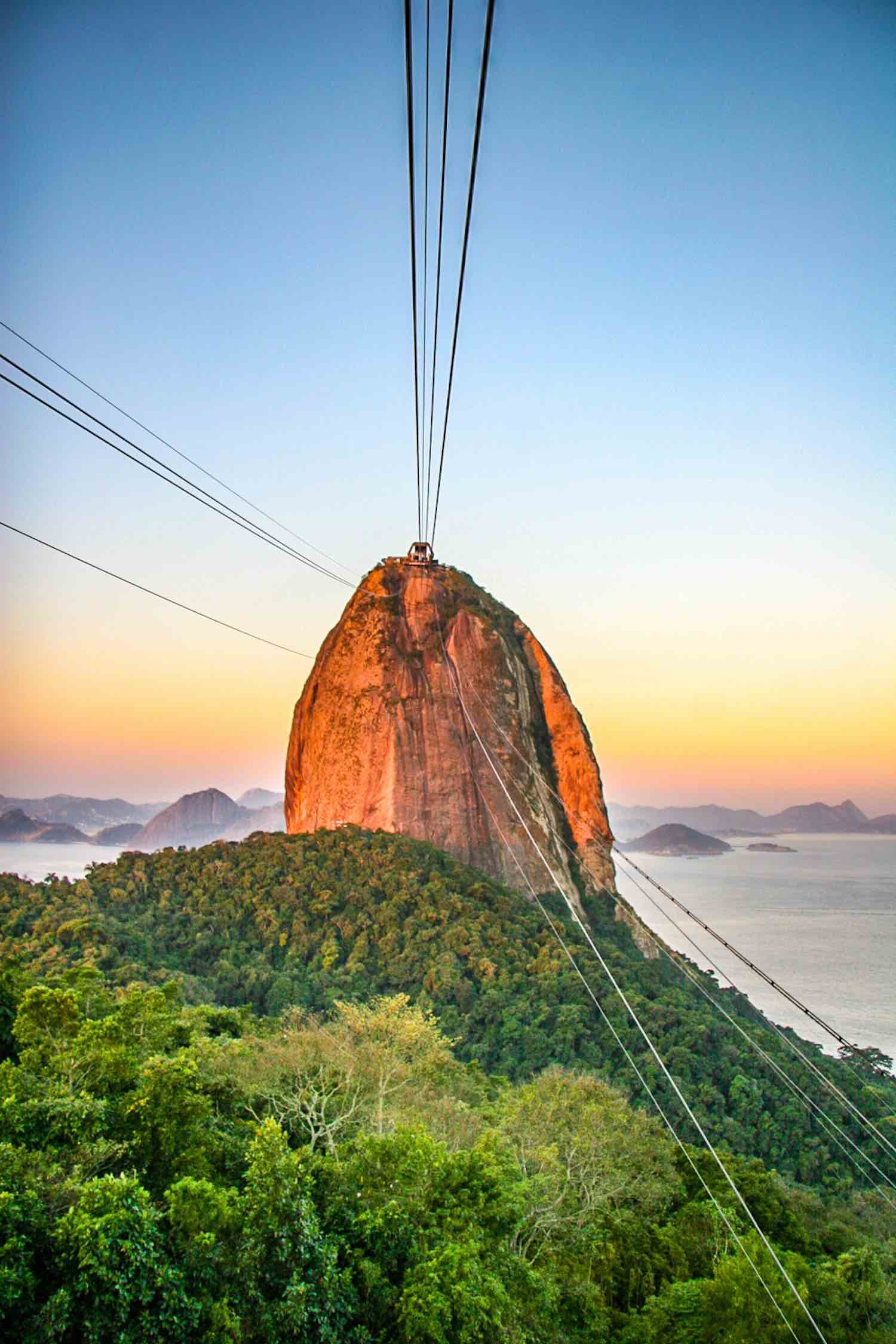 Brazil-Private-Custom-Travel-Design-Rio-de-Janiero-Sugarloaf-Sun-Tram Rio De Janiero sky tram with orange sunset background