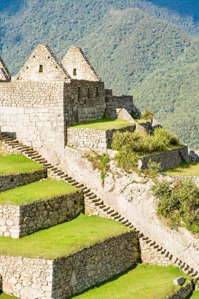 Private-Custom-Travel-Design-Machu-Picchu-Residential-Vertical Stepped residential terraces cut into steep green hillside at Machu Pichu Inca ruin site in Peru