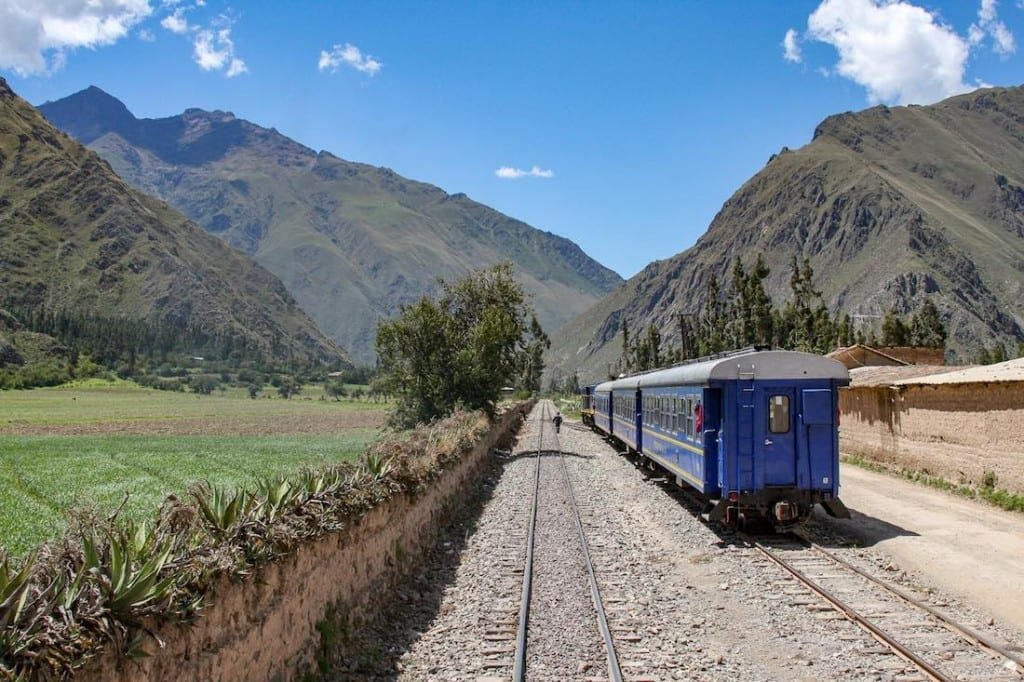 Private-Custom-Travel-Design-Machu-Picchu-Train Blue train cars with white roofs en route to Agua Calientes, near Machu Picchu