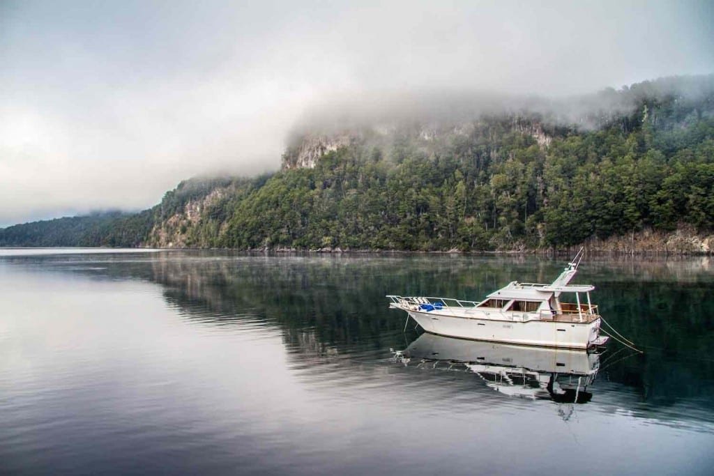 Custom-Travel-Argentina-Lake-District-Las-Balsas-Boat Small white fishing boat in lake near Bariloche, Argentina, Patagonia
