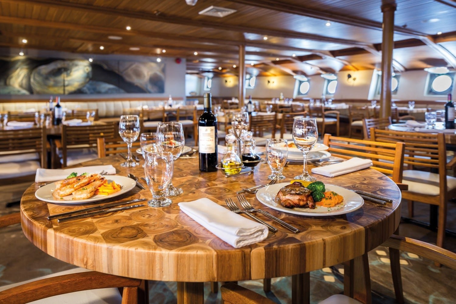 lonesomegeorgerestaurant3 table set for dinner Lonesome George restaurant on MV Legend Galapagos Cruise Ship