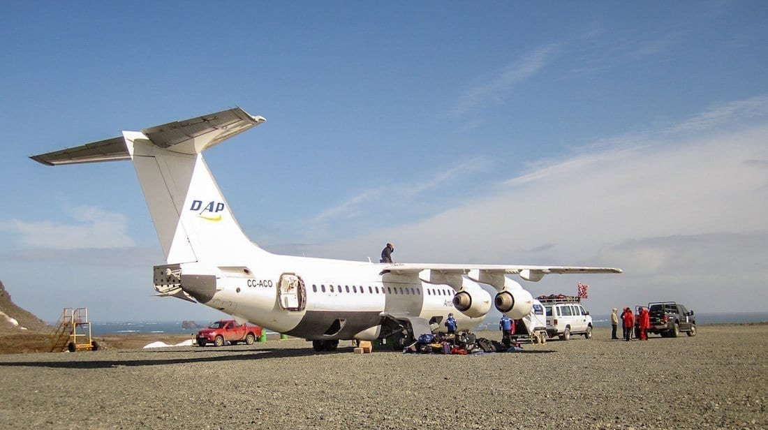 Antarctic-Air-Cruise-Luxury-Antarctica-Vacation Large white charter jet being loaded with luggage for trip to Antarctica