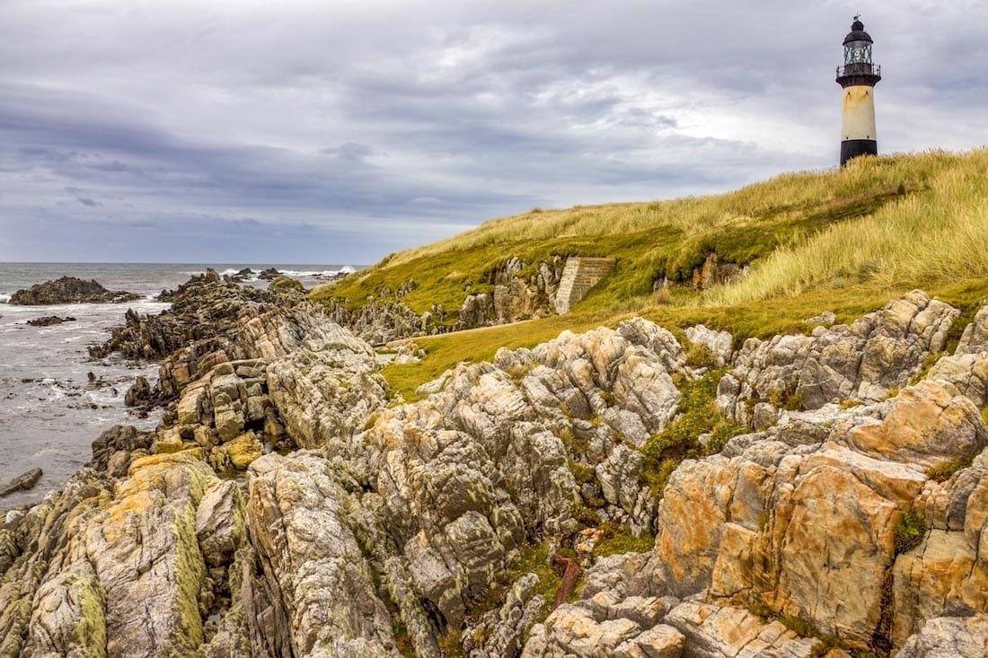 Landed-Travel-Private-Travel-Cape-Pembroke-Lighthouse-Falklands-Antarctica Lighthouse on Rocky shores of Cape Pembroke, photographed during an Antarctic Cruise Expedition in the Falkland Islands near Antarctica