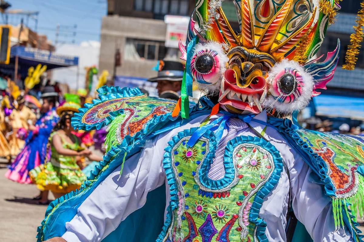Private-Custom-Travel-Peru-Lake-Titicaca-Festival-9 Man in colorful celebratory robe and mask at a festival in Peru near Lake Titicaca