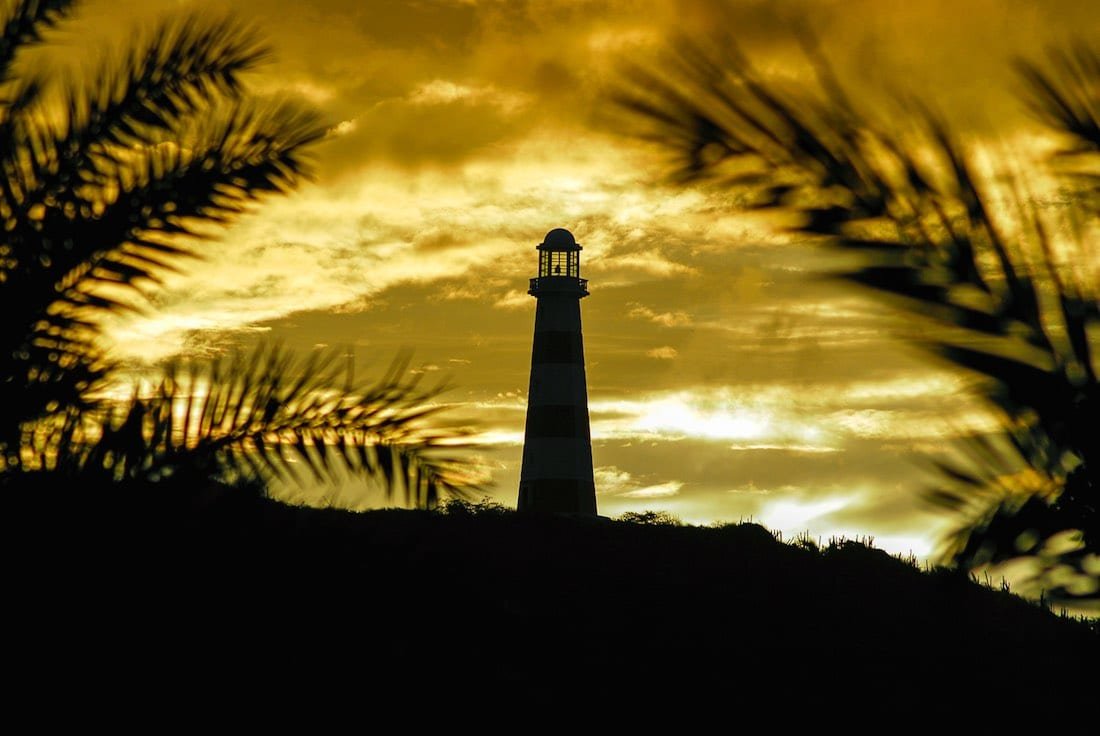 Private-Travel-Custom-Travel-La-Paloma-Lighthouse-1 Silhouette of La Paloma lighthouse with golden sunset in background