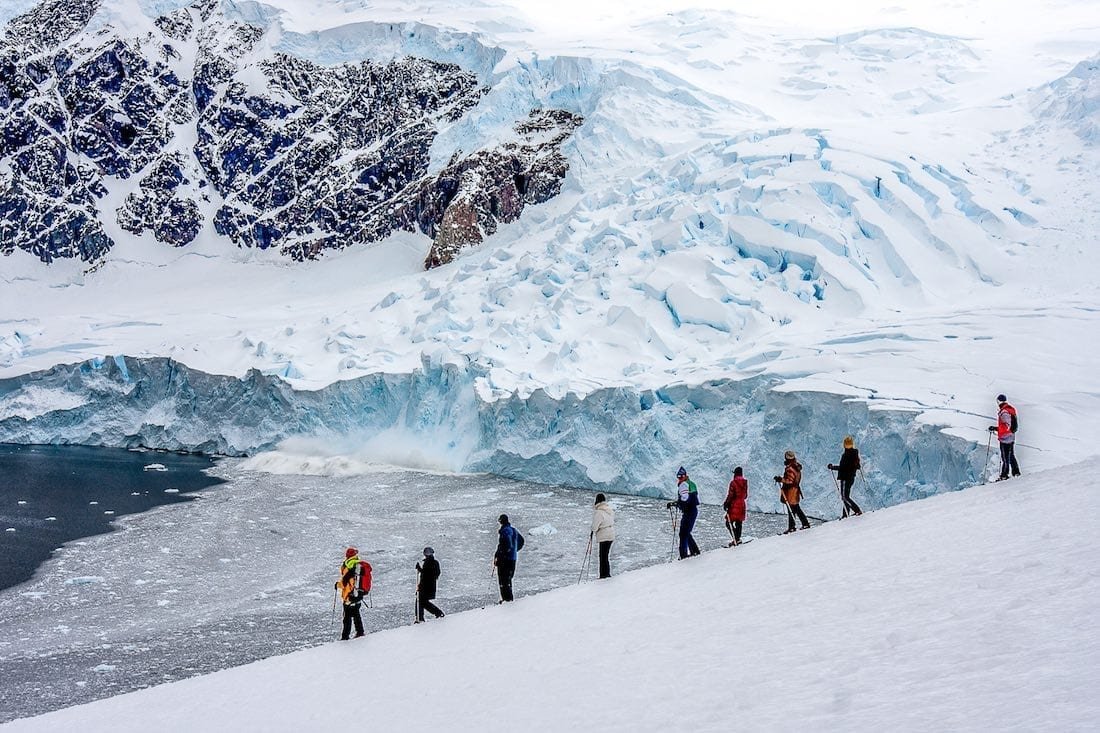 Trip-to-Antarctica-Tour-Group Tour group on a trip to Antarctica, hiking near a glacier