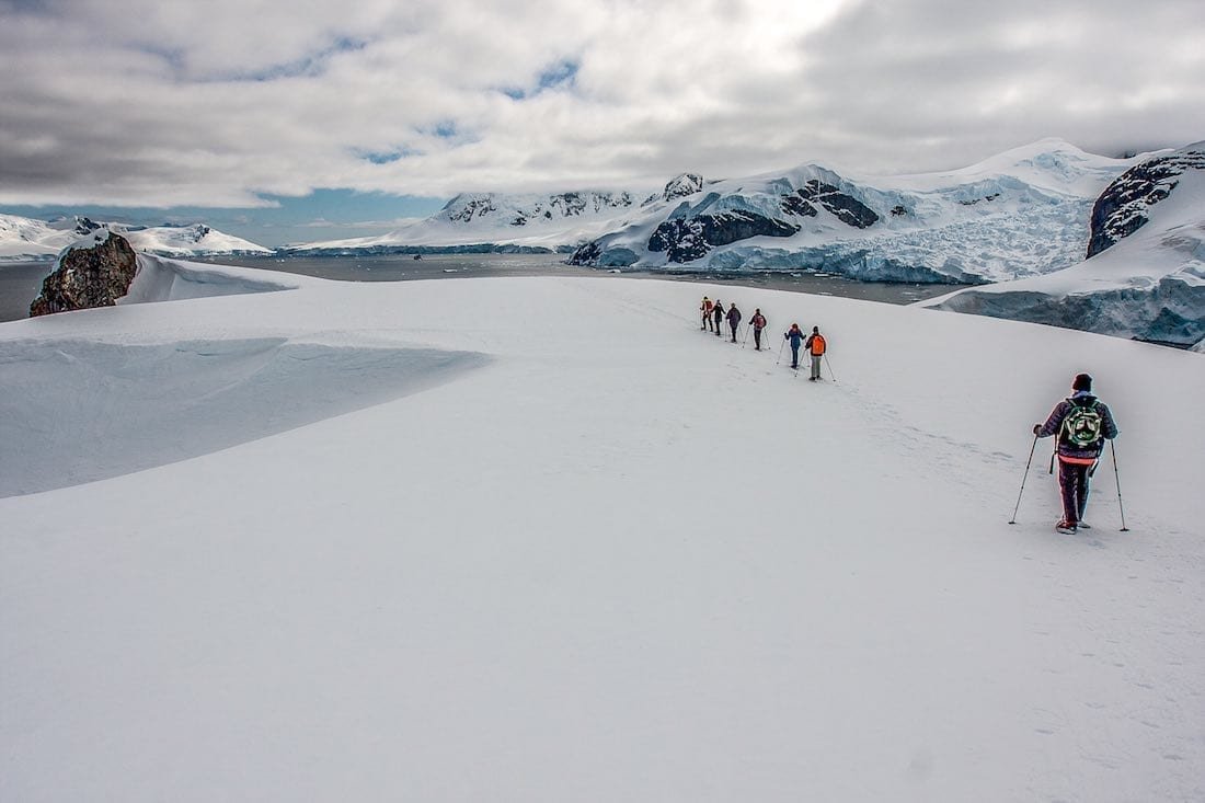 Union-Glacier-Antarctica-hotel-Hike Group of people on a trip to Antarctica hiking near Union Glacier camp, an Antarctic hotel alternative