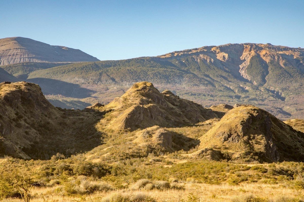 Private-Travel-Chile-Aysen-11 Rolling yellow hills of Aysen Chile, photographed on a road trip down Ruta 7 in Chilean Patagonia