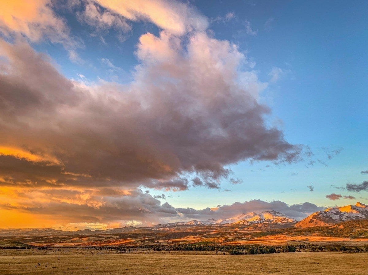 Private-Travel-Chile-Aysen-217 Deep orange sunset rolling over a cloudy sky in Chilean Patagonia with the Torres del Paine Mastiff in the background
