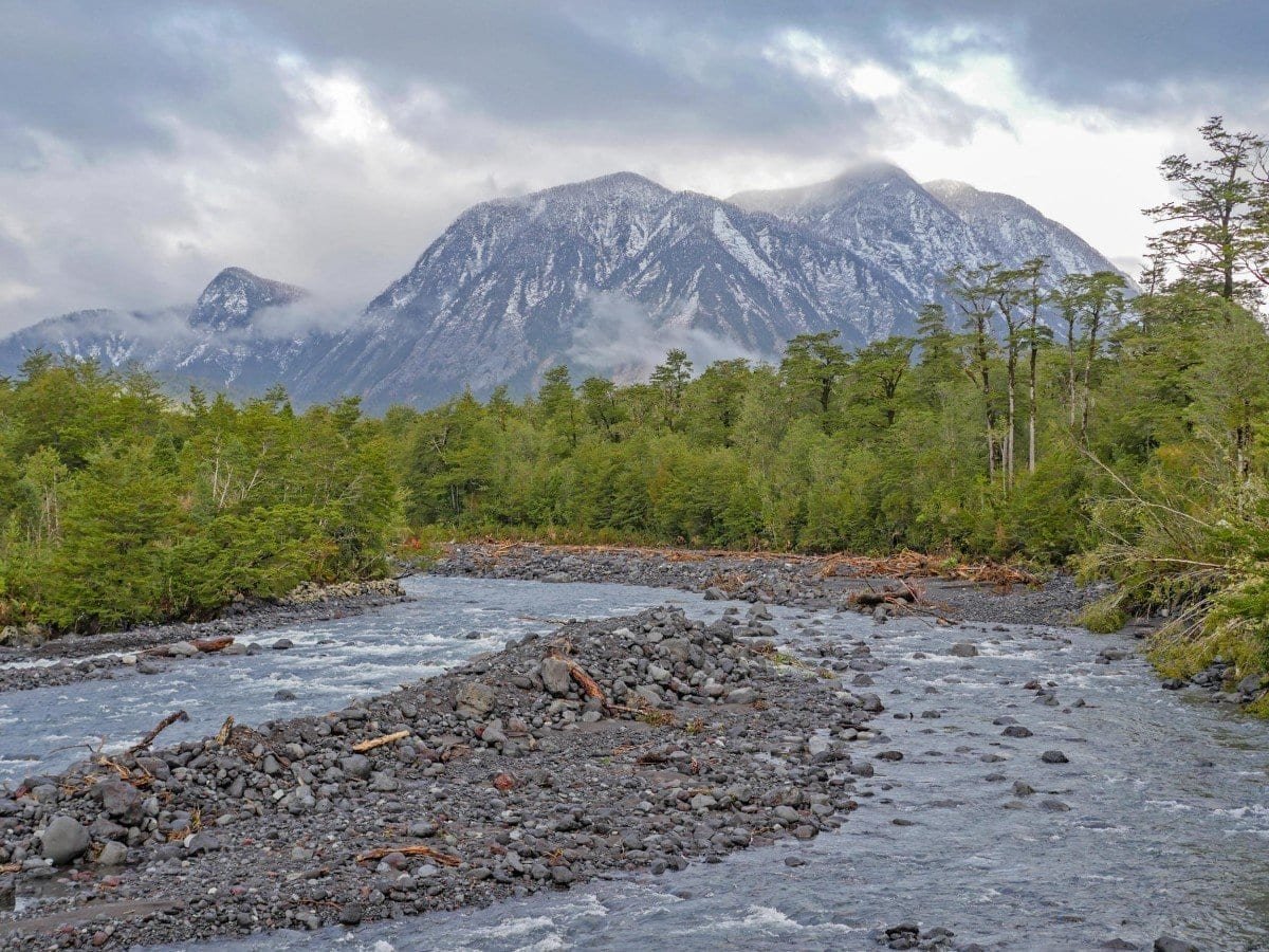 Hornopiren-Private-Travel-Chile-Aysen-227 Pebbly banks of a stream in Chilean Patagonia's Hornopiren National Park. Yates Volcano in the background