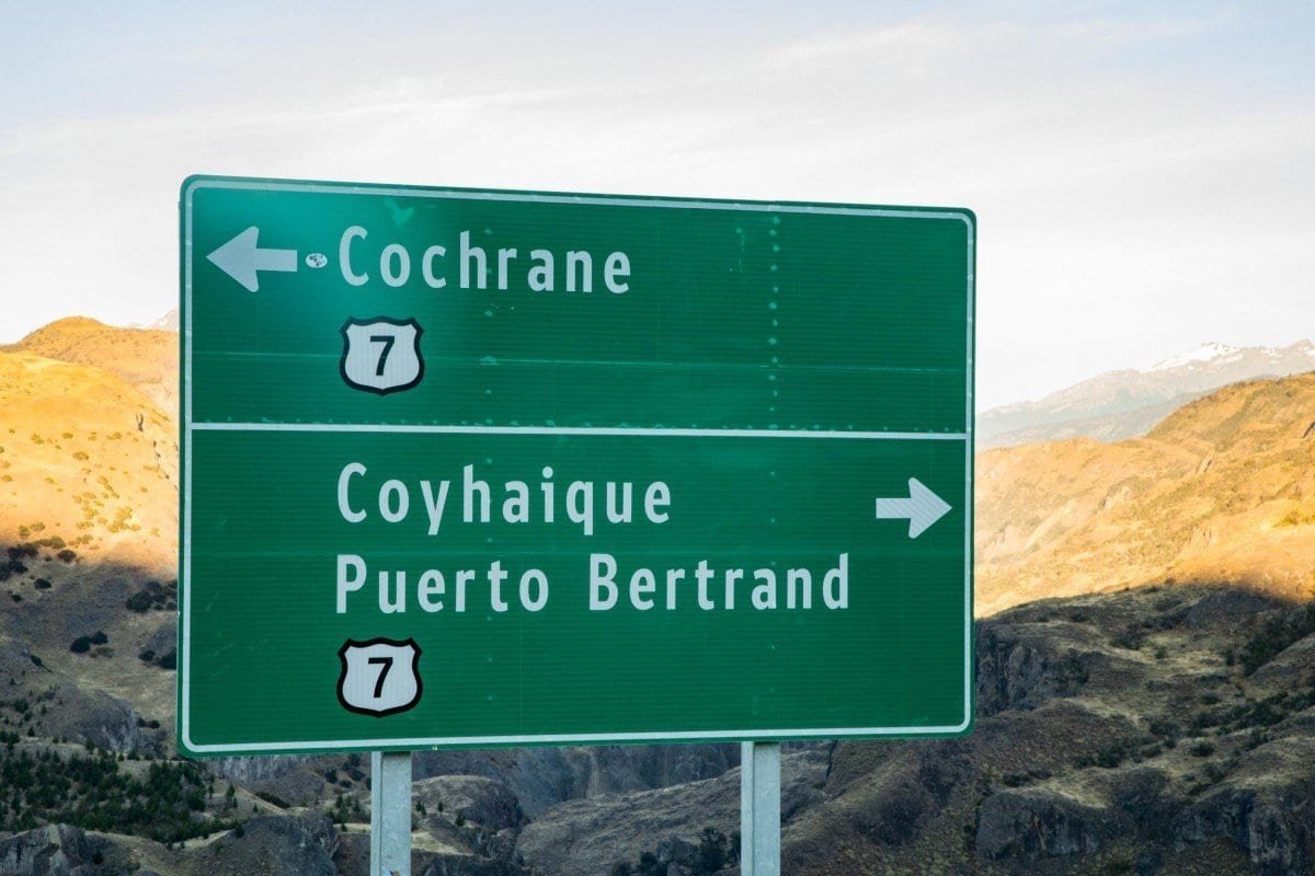 Landed-Private-Travel-Chile-Aysen-69 Large green road sign on Route 7 in Chile, marking the direction of Cotrayne in one direction and Puerto Bertrand in the other