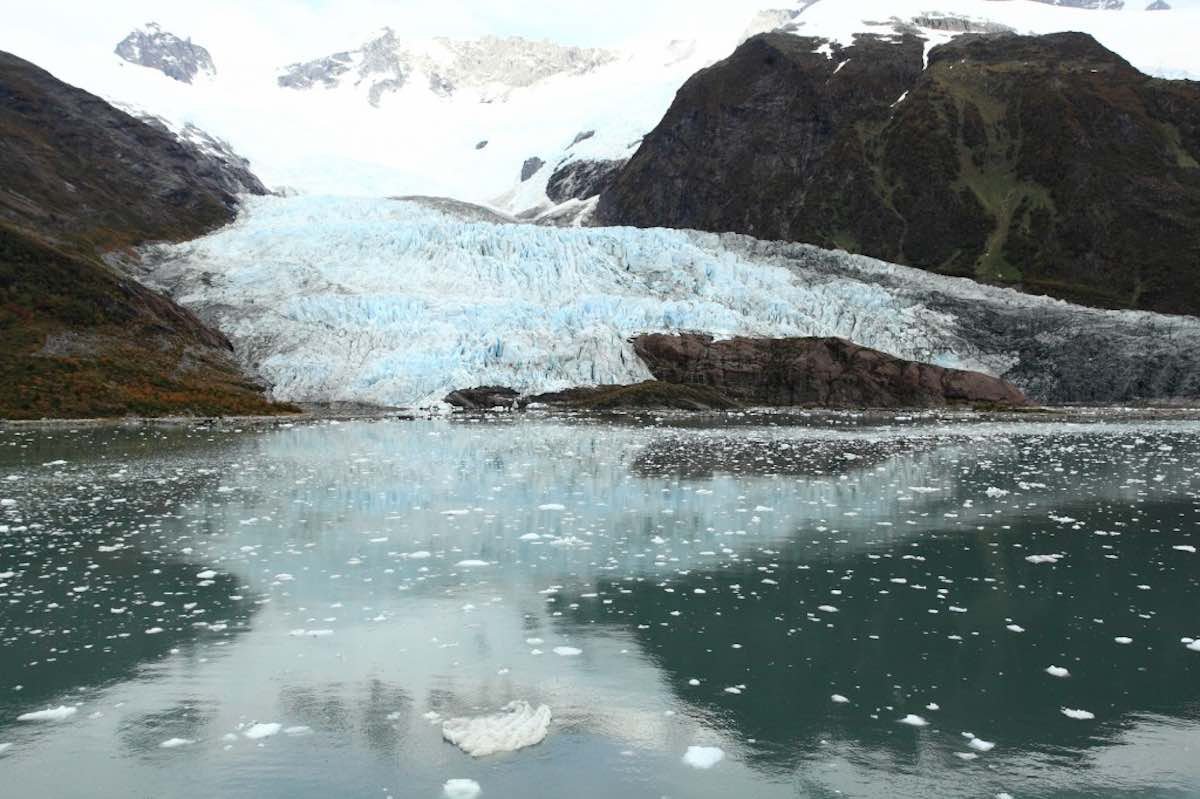 Pia-Glacier-Australis-Tours The pia glacier on Australis tours has green/blue water with ice bits floating in the water.