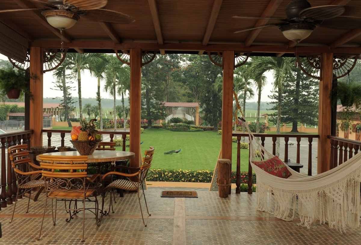 Private-Terrace-Hacienda-La-Danesa Hacienda La Danesa has a private terrace that looks onto a green field with a white hammock and table and chairs.