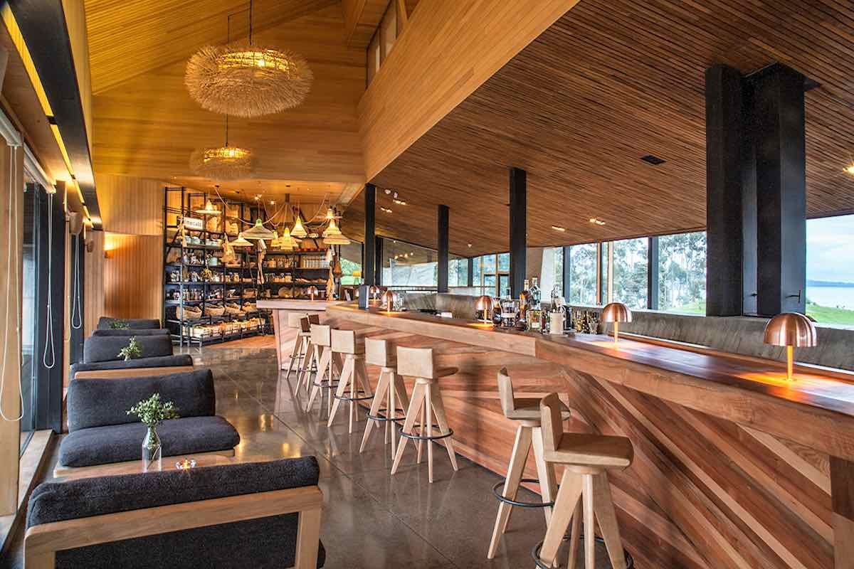 Tierra-Chiloe-bar The bar at Tierra Chiloe has all wood furnishings, a wall of alcohol and picturesque views.