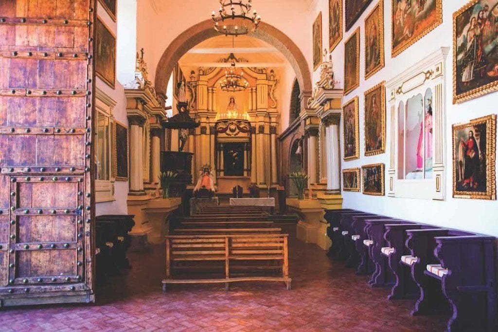 Belmond-Palacio-Nazarenas-Interior-Matt-Hind Belmond Palacio Nazarenas interior feature colonial paintings, an old church and wood furnishings.