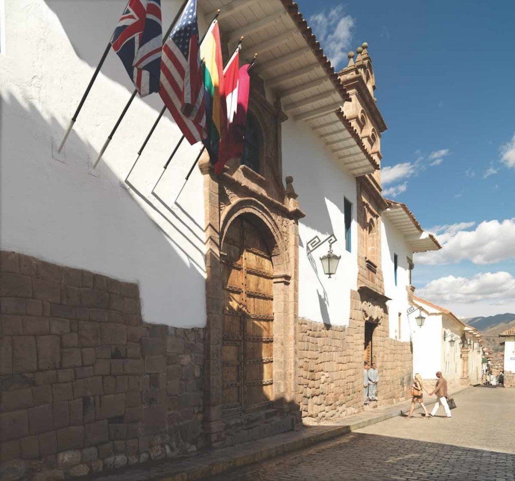 Belmond-Palacio-Nazarenas-exterior-photo-Adrian-Houston The exterior of Belmond Palacio Nazarenas features white wash walls, old stone and an old wood door.