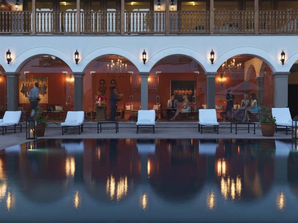 Belmond-Palacio-Nazarenas-pool-Adrian-Houston Belmond Palacio Nazarenas features a dimly lit swimming pool in front of a restaurant.